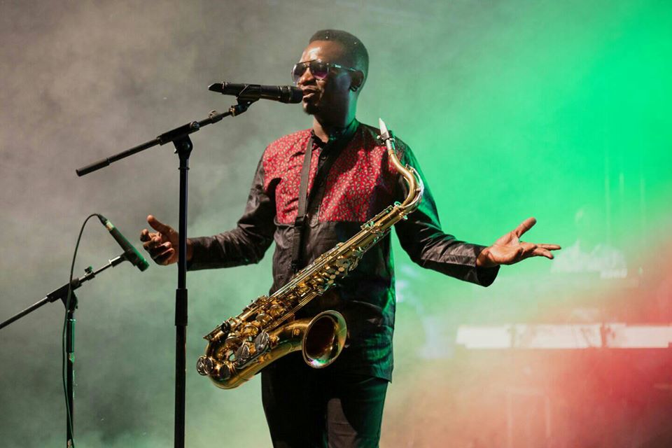 Juma Tutu performing live with saxophone and microphone