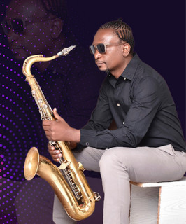 Juma Tutu seated with saxophone