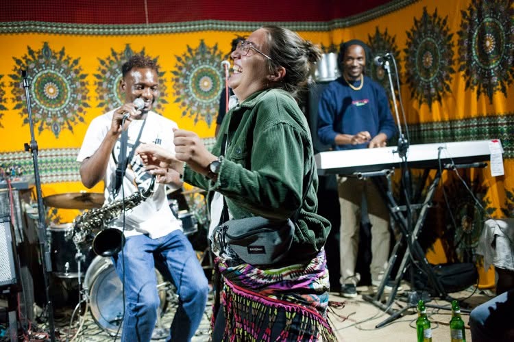 Audience member dancing during a Swahili Jazz performance