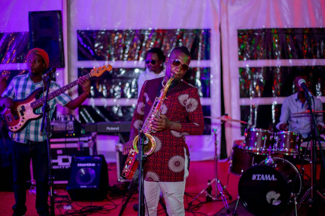Band performing under purple stage lighting