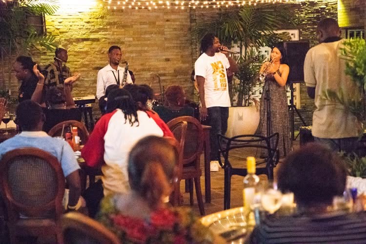 Full garden performance with audience seated nearby