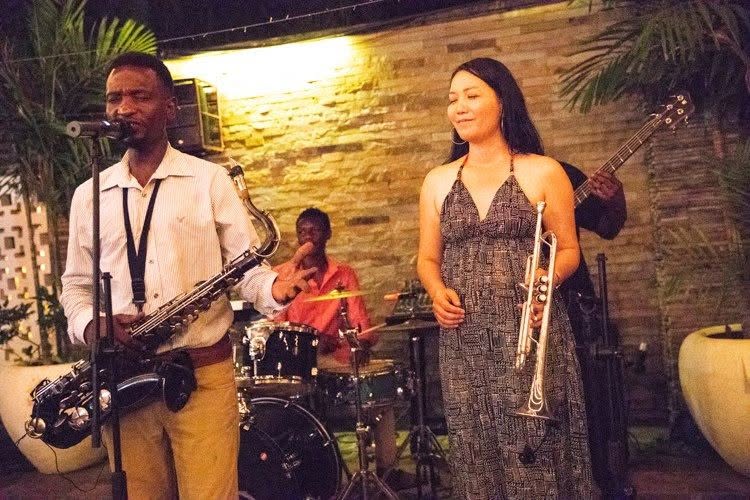 Saxophone and trumpet players at a garden performance