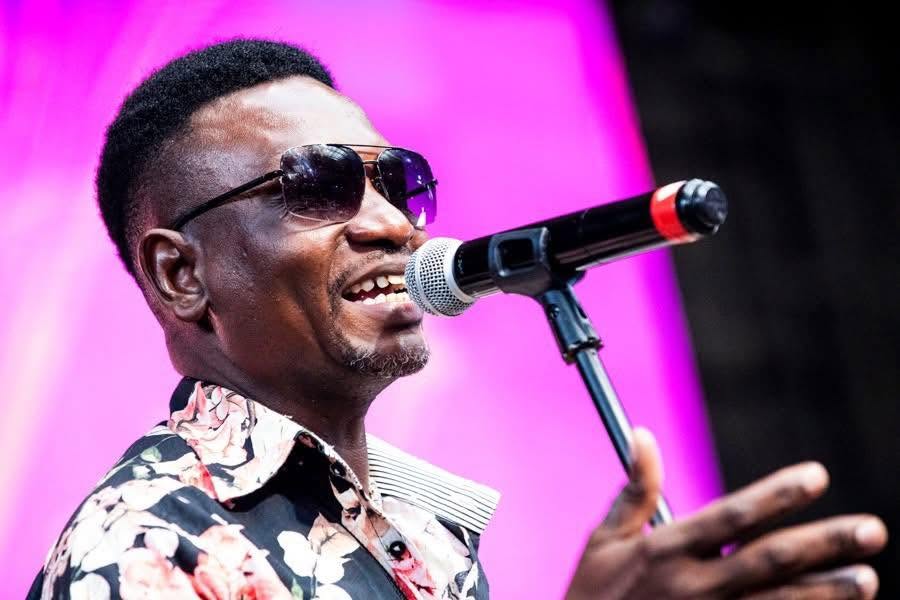 Juma Tutu smiling at a microphone