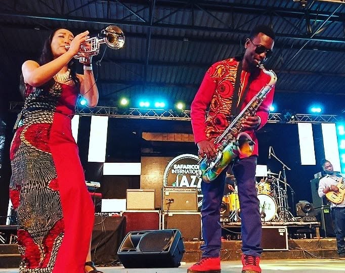 Saxophone and trumpet duet on a festival stage