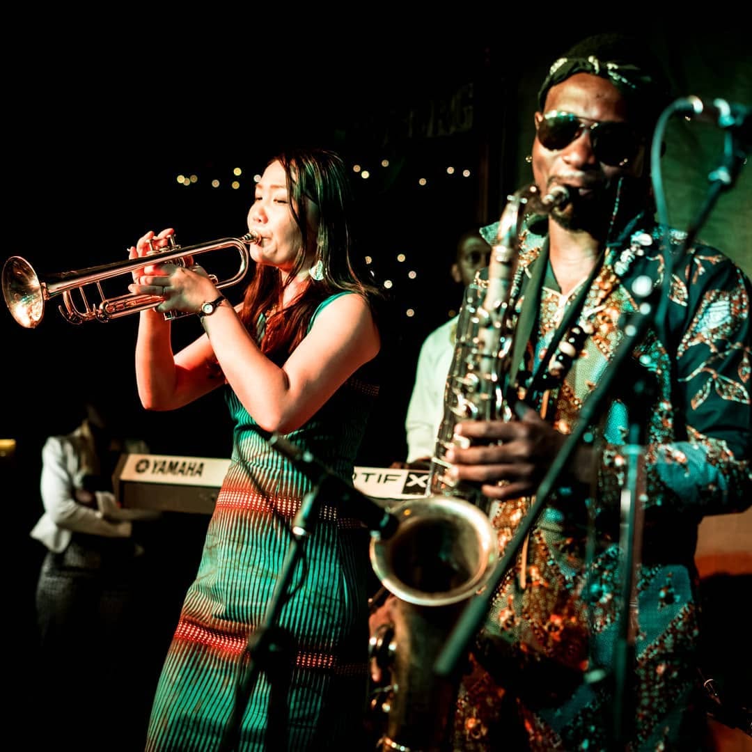 Juma Tutu and trumpet player performing at night